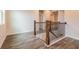 Staircase with hardwood floors, white trim, and wood railing at 142 Henley St, Canton, GA 30114