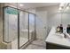 Modern bathroom with a glass-enclosed shower, marble tile, and a sleek vanity with contemporary fixtures at 264 Rockledge Sw Bnd, Powder Springs, GA 30127