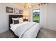 Cozy bedroom featuring a dark wood bed frame, decorative wall art and neutral colored walls with natural light at 264 Rockledge Sw Bnd, Powder Springs, GA 30127