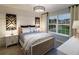 Beautiful bedroom featuring a comfortable bed, modern bedside tables, and large windows with an outdoor view at 264 Rockledge Sw Bnd, Powder Springs, GA 30127