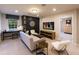 Relaxing living room featuring a large screen television, comfortable seating and bright natural light at 264 Rockledge Sw Bnd, Powder Springs, GA 30127