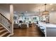 Open-concept living space featuring a kitchen island, living room fireplace, and staircase at 264 Rockledge Sw Bnd, Powder Springs, GA 30127