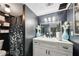 Bathroom with a large vanity, decorative mirror, and modern fixtures at 3087 Sanibel Sw Dr, Stone Mountain, GA 30087