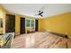 Spacious bedroom with yellow walls, hardwood floors, and large windows at 3087 Sanibel Sw Dr, Stone Mountain, GA 30087