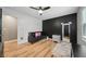 Bright bedroom with hardwood floors, a ceiling fan, a black accent wall, and a modern aesthetic at 3087 Sanibel Sw Dr, Stone Mountain, GA 30087