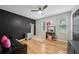 Bedroom featuring black accent wall, wood floors, and natural lighting at 3087 Sanibel Sw Dr, Stone Mountain, GA 30087