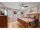 Bedroom featuring natural lighting, wood floors, ceiling fan, and closet at 3087 Sanibel Sw Dr, Stone Mountain, GA 30087