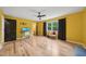 Large bedroom with bright yellow walls, hardwood floors, and natural light at 3087 Sanibel Sw Dr, Stone Mountain, GA 30087