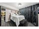 Cozy bedroom with a white bed, dark flooring, and elegant curtains at 3087 Sanibel Sw Dr, Stone Mountain, GA 30087