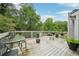 Wooden deck with chairs, small tables, and potted plants at 3087 Sanibel Sw Dr, Stone Mountain, GA 30087