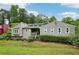 Single-Gathering home with a covered front porch, landscaped yard, and large windows at 3087 Sanibel Sw Dr, Stone Mountain, GA 30087