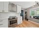 Updated kitchen featuring stainless steel range, white cabinetry and subway tile backsplash at 3087 Sanibel Sw Dr, Stone Mountain, GA 30087