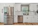 A kitchen featuring stainless steel appliances, white cabinetry and subway tile backsplash at 3087 Sanibel Sw Dr, Stone Mountain, GA 30087