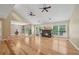 Spacious living room featuring hardwood floors, fireplace, and ceiling fans at 3087 Sanibel Sw Dr, Stone Mountain, GA 30087