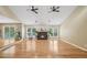 Open-concept living room with hardwood floors, fireplace, and sliding glass door to the deck at 3087 Sanibel Sw Dr, Stone Mountain, GA 30087