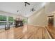 Bright living room with hardwood floors, fireplace, large windows, and ceiling fans at 3087 Sanibel Sw Dr, Stone Mountain, GA 30087