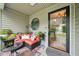 Cozy covered porch with comfortable seating, plants, and decorative accents at 3087 Sanibel Sw Dr, Stone Mountain, GA 30087