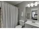 Clean bathroom featuring a vanity, toilet, and shower with gray tile at 6606 Wellington Sq, Norcross, GA 30093