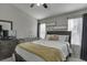 Cozy bedroom featuring a ceiling fan, wooden bed frame, and neutral-toned walls at 6606 Wellington Sq, Norcross, GA 30093