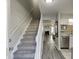 Bright entryway with sleek flooring, a staircase, and an open view to a cozy living space at 6606 Wellington Sq, Norcross, GA 30093
