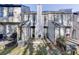 View of the home's back exterior, showcasing a patio and wooded backdrop at 6606 Wellington Sq, Norcross, GA 30093