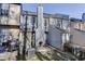 Rear exterior of townhomes with patios, barbecue grills, and wooded surroundings at 6606 Wellington Sq, Norcross, GA 30093