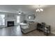 Cozy living room with a fireplace, a ceiling fan, natural light, and a gray sectional couch at 6606 Wellington Sq, Norcross, GA 30093