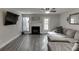 Cozy living room with a fireplace, a ceiling fan, natural light, and a gray sectional couch at 6606 Wellington Sq, Norcross, GA 30093
