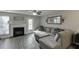Cozy living room features a fireplace, ceiling fan, and comfortable sectional sofa at 6606 Wellington Sq, Norcross, GA 30093