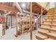 Unfinished basement showing exposed beams, a sturdy staircase, and ample space for customization at 2388 Cannon Hill Rd, Lilburn, GA 30047