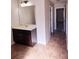 Bright bathroom featuring a dark wood vanity, neutral countertop, large mirror and tile flooring at 2622 Glenbrook, Loganville, GA 30012