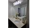 Well-lit bathroom featuring dual sinks, neutral counters, large mirror with vanity lights at 2622 Glenbrook, Loganville, GA 30012