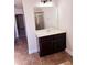 Bathroom boasting a dark wood vanity, neutral countertop, framed mirror, and shower at 2622 Glenbrook, Loganville, GA 30012