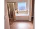 Bathroom featuring a soaking tub, a separate shower, and a large window at 2622 Glenbrook, Loganville, GA 30012