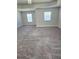 Spacious bedroom features plush carpet, tray ceiling, and natural light from two windows at 2622 Glenbrook, Loganville, GA 30012