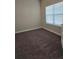 A bright bedroom featuring a window and neutral carpet at 2622 Glenbrook, Loganville, GA 30012