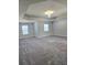 Large bedroom with plush carpet, tray ceiling and a chandelier at 2622 Glenbrook, Loganville, GA 30012
