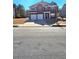 Two-story home featuring a brick facade, double garage, manicured lawn, and traditional architectural details at 2622 Glenbrook, Loganville, GA 30012