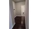 Hallway featuring dark laminate wood flooring and an adjoining bathroom at 2622 Glenbrook, Loganville, GA 30012