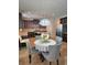 Beautiful eat-in kitchen area with chandelier, gray chairs and stainless steel appliances at 2622 Glenbrook, Loganville, GA 30012