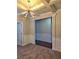 Stylish living room featuring tray ceiling, modern chandelier, neutral walls, and hardwood floors at 2622 Glenbrook, Loganville, GA 30012