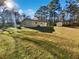 A large backyard with a shed and scattered trees offers plenty of room for recreation at 3103 Mote Rd, Covington, GA 30016