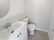 Compact half-bathroom featuring a modern vanity with a sink and a toilet at 3103 Mote Rd, Covington, GA 30016
