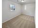 Cozy bedroom with neutral carpeting, a window with backyard views, and freshly painted white walls at 3103 Mote Rd, Covington, GA 30016