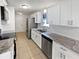 Modern kitchen featuring stainless steel appliances, white cabinets, and granite countertops at 3103 Mote Rd, Covington, GA 30016