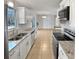 Modern kitchen with stainless steel appliances, white cabinets, and granite countertops, open to the living area at 3103 Mote Rd, Covington, GA 30016