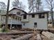 Two-story home exterior features a partially covered white wood deck, and mature trees surrounding the property at 457 Rockborough Ter, Stone Mountain, GA 30083