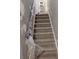 Carpeted stairway with plastic wrap on the wooden railing, ready for renovation at 457 Rockborough Ter, Stone Mountain, GA 30083