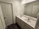 Double vanity bathroom with modern fixtures, white cabinets, and a large mirror at 656 Friesland Dr, Hampton, GA 30228