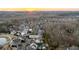 Aerial view showing a beautiful home and neighborhood surrounded by lush greenery at sunset at 7165 Cordery Rd, Cumming, GA 30040
